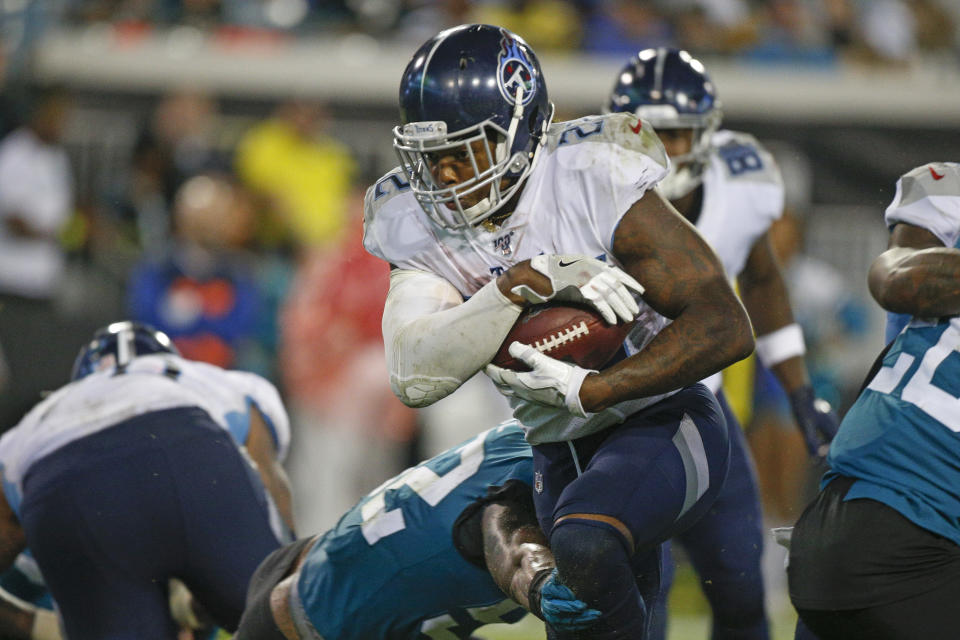 Tennessee Titans running back Derrick Henry, center, runs past Jacksonville Jaguars linebacker Najee Goode, lower left, for a 1-yard touchdown during the second half of an NFL football game, Thursday, Sept. 19, 2019, in Jacksonville, Fla. (AP Photo/Stephen B. Morton)