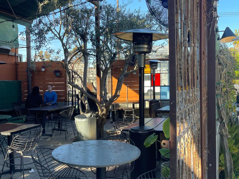 The outside patio at MizLaLa in Los Angeles with stained glass and string lights.