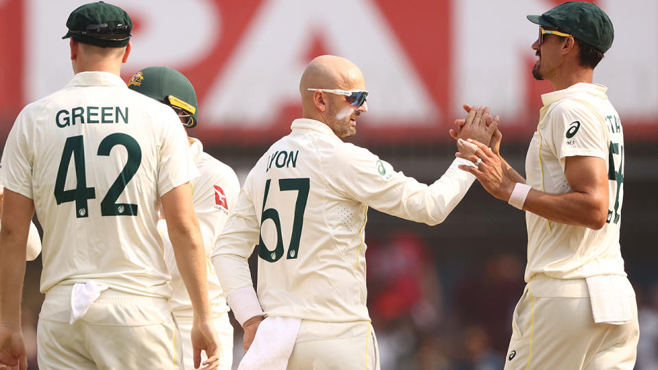 Nathan Lyon is congratulated by Australian teammates.