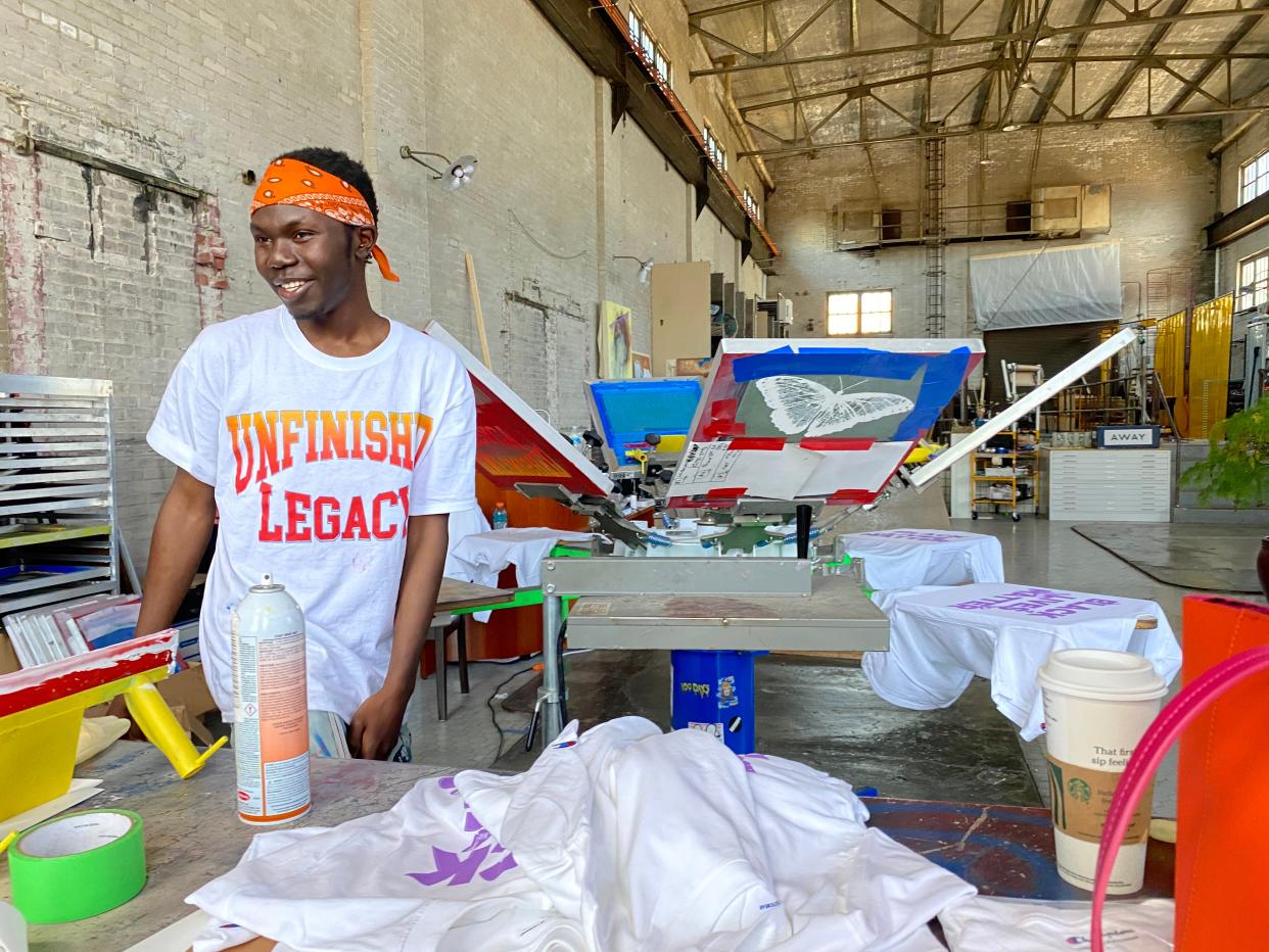 Unfinished Legacy creator Brema Brema works on Black Lives Matter shirts.