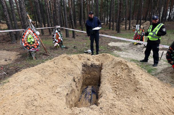 PHOTO:  Investigators research the killing of three Izium residents as a car was shelled when the Russian convoy entered Izium in March 2022, Izium, Kharkiv Region, northeastern Ukraine, Oct. 31, 2022. (Vyacheslav Madiyevskyy/AP)