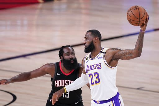 Los Angeles Lakers' LeBron James (23) is defended by Houston Rockets' James Harden during the first half of an NBA conference semifinal playoff basketball game Saturday, Sept. 12, 2020, in Lake Buena Vista, Fla. (AP Photo/Mark J. Terrill)