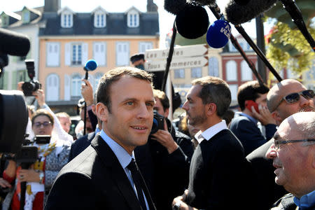 Emmanuel Macron, head of the political movement En Marche ! ( Onwards !) and candidate for the 2017 presidential election, talks with residents during a campaign visit in Bagneres de Bigorre, France, April 12, 2017. REUTERS/Eric Feferberg/Pool