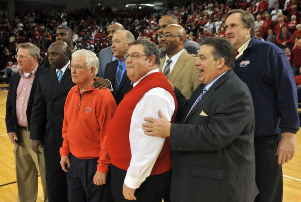 Players and staff members of Bradley's 1981-82 team that won the NIT was honored at halftime during Wednesday night's game at Renaissance Coliseum. Front row, from left, are sports information director Joe Dalfonso, player Willie Scott, athletics director Ron Ferguson, manager Eugene Link and associate head coach Tony Barone. In the back row, from left, are players Mitchell Anderson, Pierre Cooper, Eddie Mathews, Donald Reese, Barney Mines and assistant coach Jay Eck.