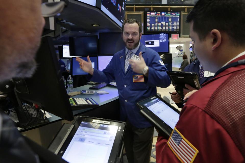 Specialist Charles Boeddinghaus, center works at his post on the floor of the New York Stock Exchange, Tuesday, Jan. 17, 2017. Stocks are opening slightly lower on Wall Street, led by declines in banks and health care companies. (AP Photo/Richard Drew)