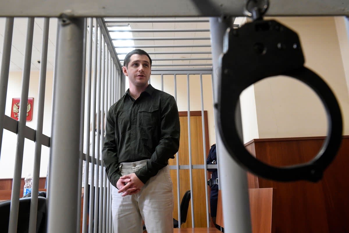 US ex-marine Trevor Reed, charged with attacking police, stands inside a defendants' cage during a court hearing in Moscow on March 11, 2020 (AFP via Getty Images)