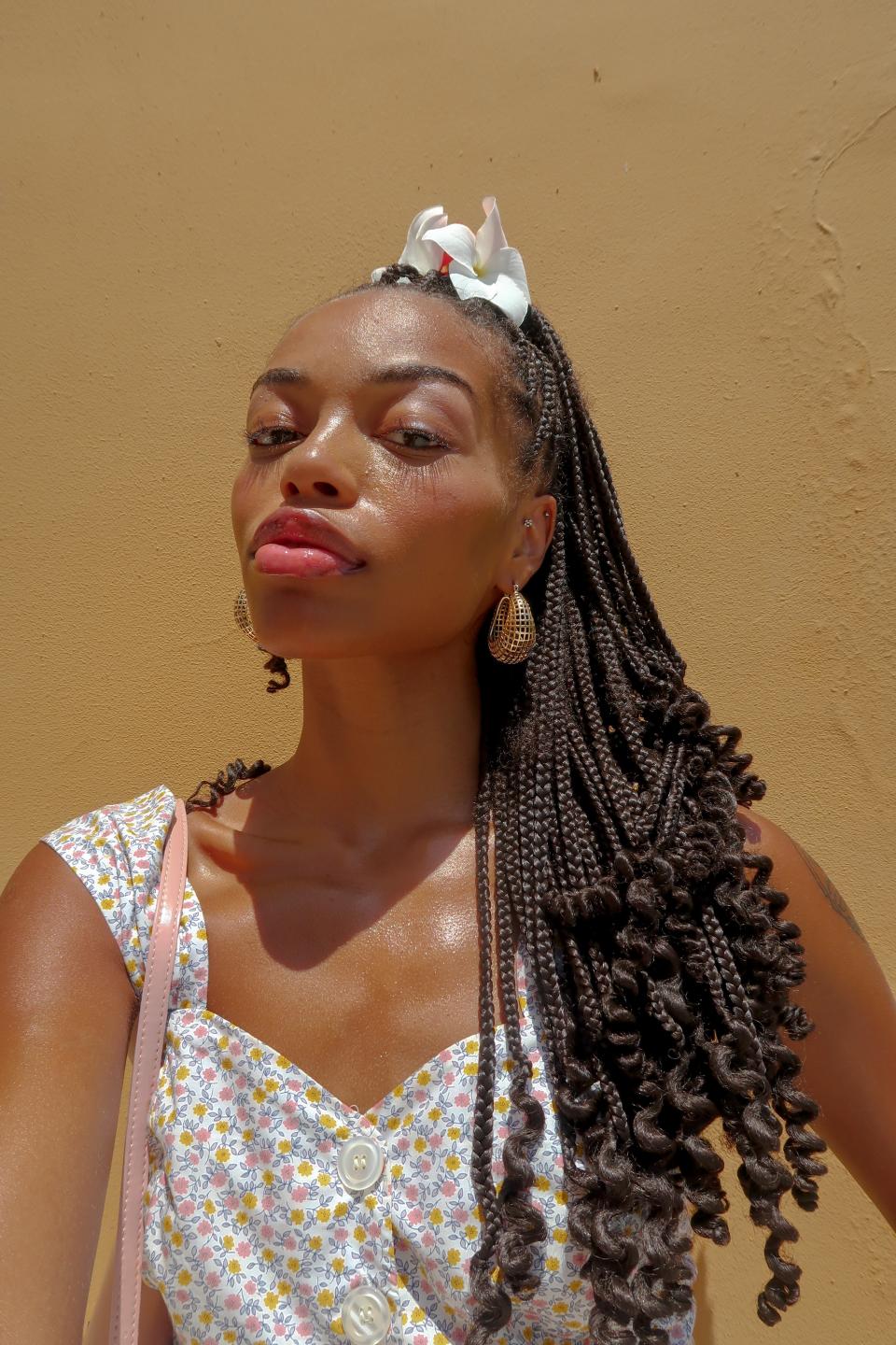 “I dabble in braided hairstyles year-round, but single braids are just so carefree for summers. Half-up, half-down styles are so elegant! Since high school, I’ve loved adding flowers to my Afro, but now I’m experimenting with them in my braids.”