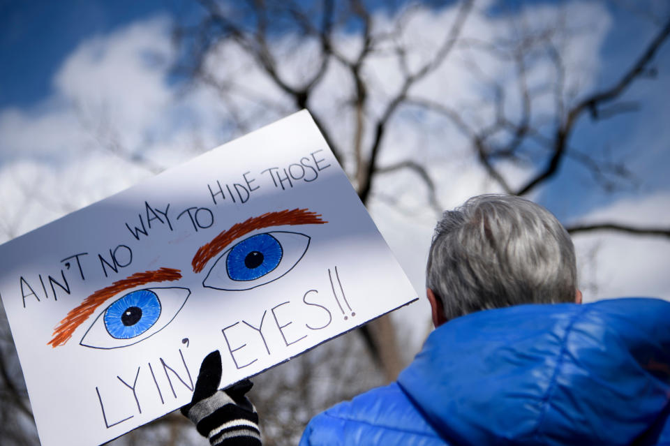 An activist holds a sign while gathering with others for a President's Day protest against US President Donald Trump in Lafayette Square near the White House Feb. 18, 2019 in Washington, DC.  (Photo: Brendan Smialowski/AFP/Getty Images)