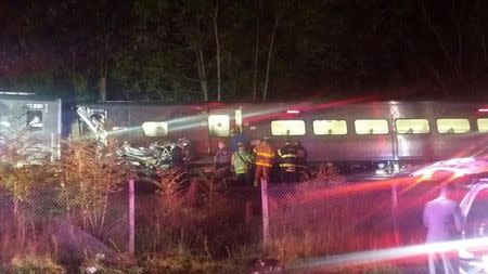 A train sits derailed near the community of New Hyde Park on Long Island in New York, U.S., October 8, 2016. Sarah Qamar/Handout via REUTERS