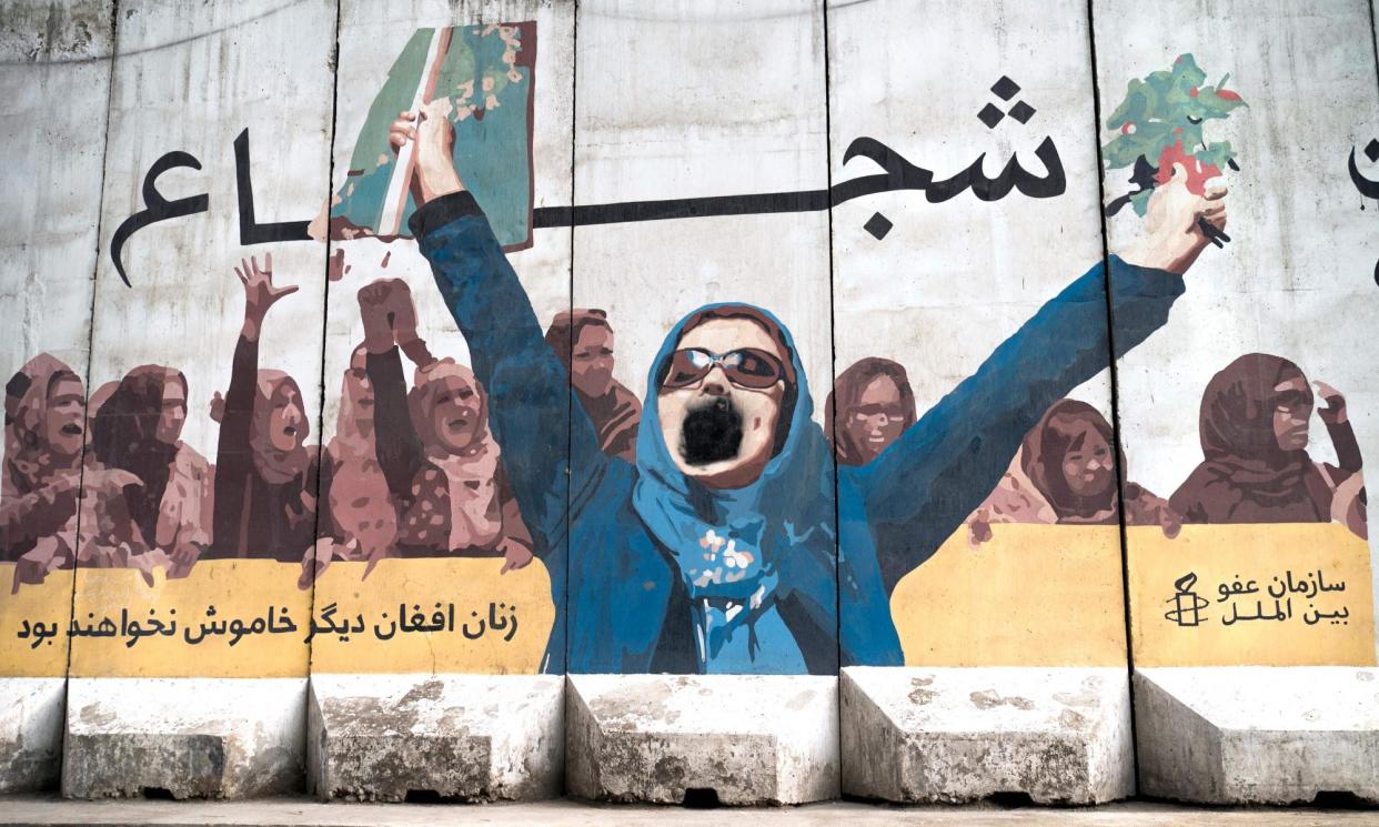 <span>A mural in Kabul shows protesting women. The response from the Taliban to protesters has been brutal.</span><span>Photograph: Wakil Kohsar/AFP/Getty Images</span>