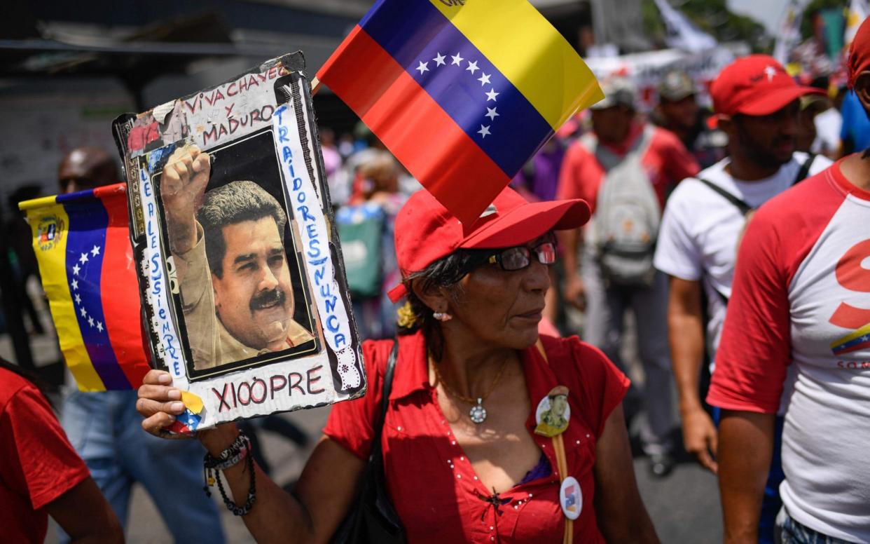 Government supporters attend a rally in the surroundings of Miraflores Presidential Palace in Caracas on May 20, 2019 to mark the one year anniversary of President Nicolas Maduro's re-election - AFP