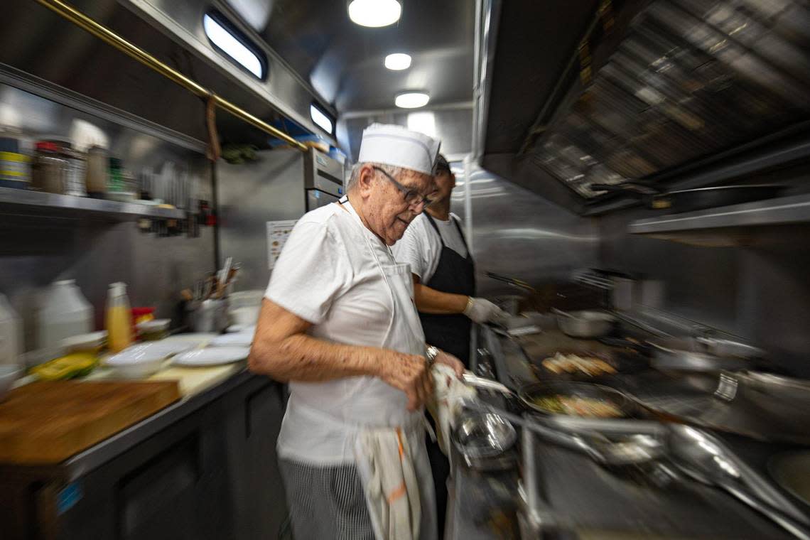 Chef Quintin “Nene” Larios sautees ingredients in the kitchen at Royd’s alongside Angel Ricardo, his kitchen assistant of more than 12 years.