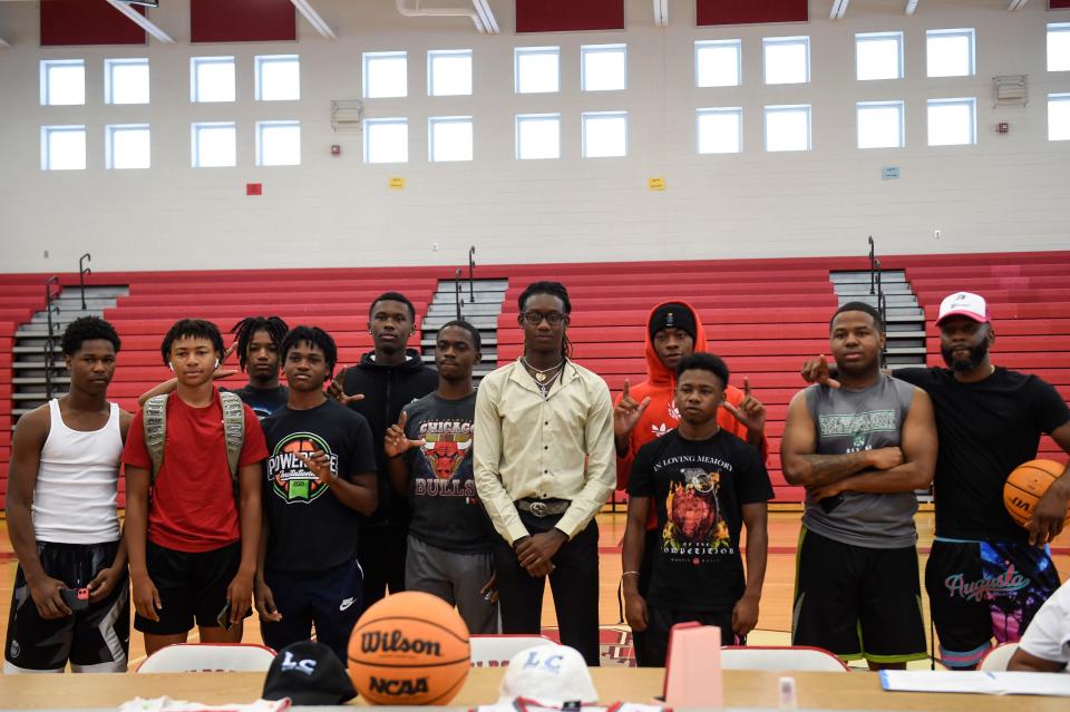 James Nipper (center) poses for a photo with other members of the Laney boys basketball team during his signing at Laney High School on Friday, June 10, 2022. Nipper will play point guard at Livingstone College in North Carolina in the fall. 
