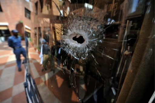 This photo taken on March 3, 2009 shows a Pakistani policeman standing beside the bullet?ridden bus