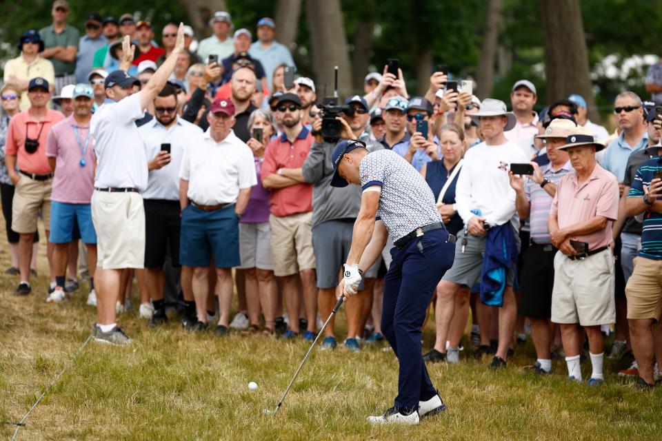 Fans watch as Justin Thomas of the United States plays a second shot on the 12th hole (Getty Images)