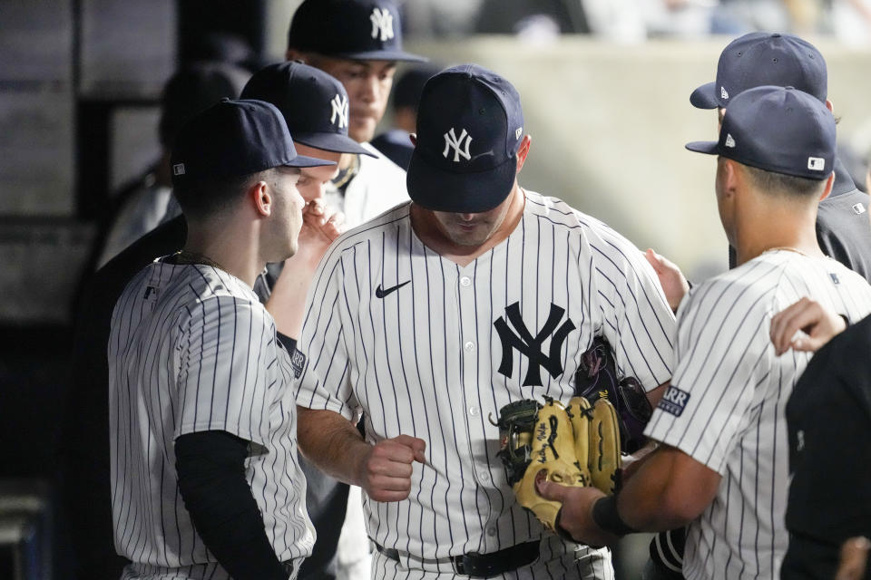 New York Yankees pitcher Carlos Rodon, center, reacts as he enters the dugout after being removed in the seventh inning of a baseball game against the Miami Marlins, Tuesday, April 9, 2024, in New York. (AP Photo/Mary Altaffer)
