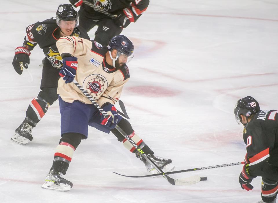 Peoria's Joseph Drapluk (7) moves the puck between Vermilion County defenders in the second period Friday, Jan. 6, 2023 at Carver Arena. The Rivermen fell to the Bobcats 4-2.