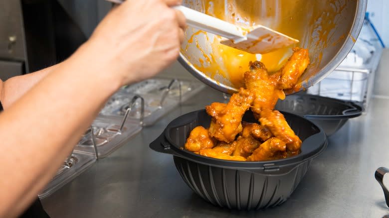 Person serving Pizza Hut wings