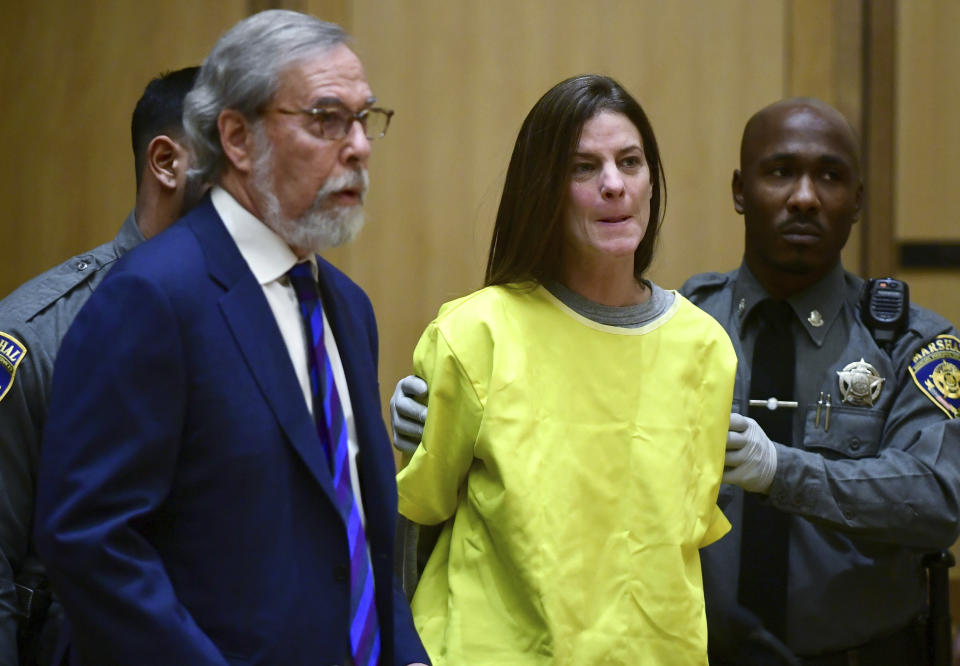 Michelle Troconis, center, is arraigned on conspiracy to commit murder charges in Stamford Superior Court Wednesday, January 8, 2020, in Stamford, Conn. Troconic had been previously charged with evidence tampering in the disappearance of Fotis Dulos' wife, Jennifer Dulos. (Erik Trautmann/Hearst Connecticut Media via AP, Pool)