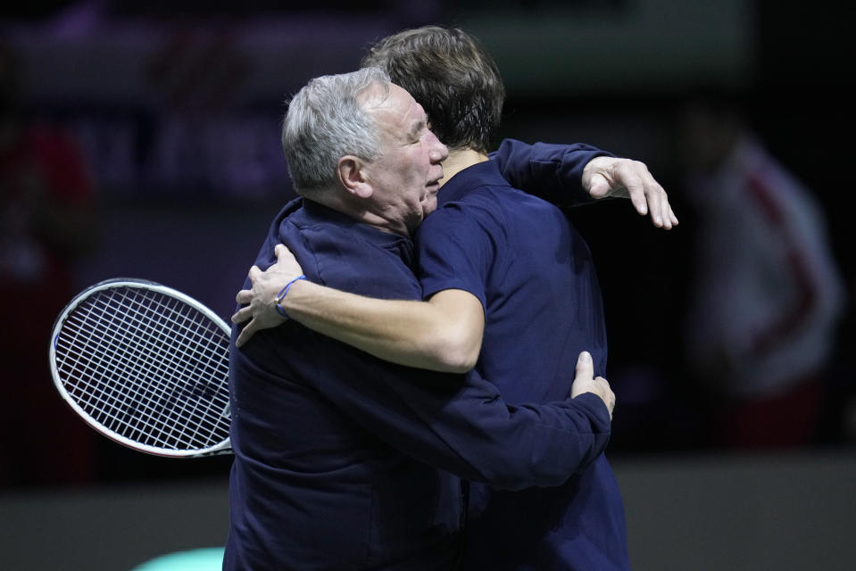 Russian Tennis Federation's Daniil Medvedev is embraced by team captain Shamil Tarpishchev as he celebrates after beating Croatia's Marin Cilic to win the Davis Cup tennis final at the Madrid Arena in Madrid, Spain, Sunday, Dec. 5, 2021. (AP Photo/Bernat Armangue)