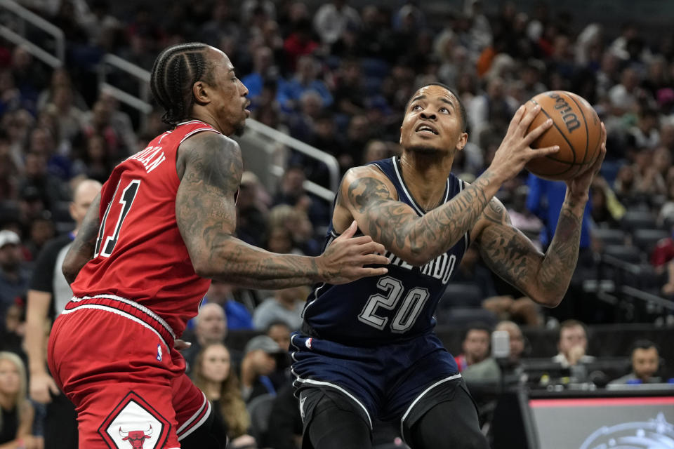 Orlando Magic guard Markelle Fultz (20) looks for a shot against Chicago Bulls forward DeMar DeRozan, left, during the first half of an NBA basketball game, Saturday, Feb. 10, 2024, in Orlando, Fla. (AP Photo/John Raoux)