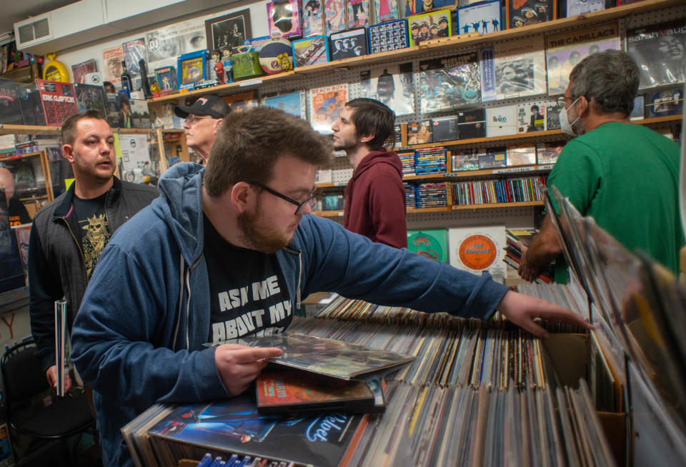 Ben Harvey, of Hatboro, browses through albums during Record Store Day, on Saturday, April 23, 2022, at Positively Records in Levittown.