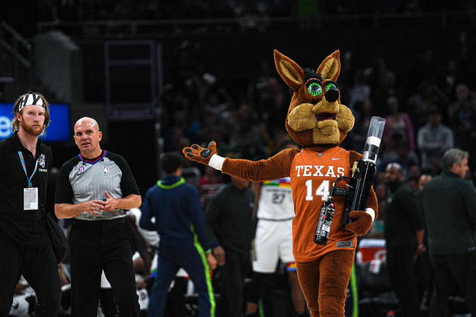 The Coyote, the San Antonio Spurs' mascot, hypes up the crowd at Moody Center while wearing a Texas Longhorns jersey during the April 8 game against the Minnesota Timberwolves. The Spurs will make a repeat swing north to Austin for two games next March.