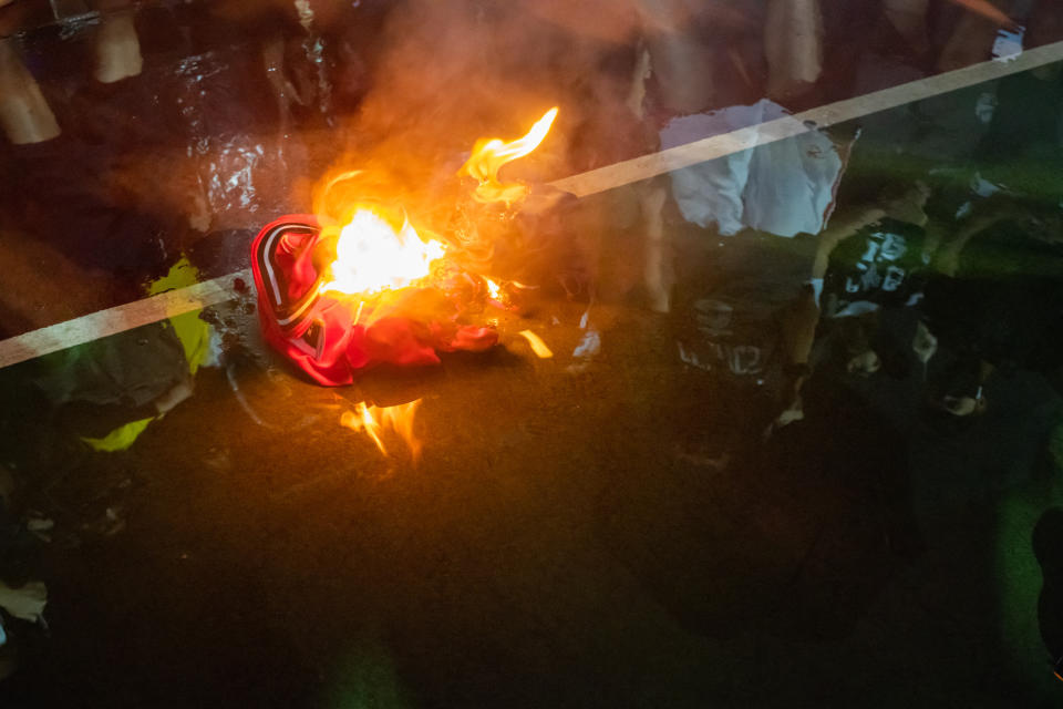 HONG KONG, CHINA - OCTOBER 15: Lebron James jersey burns during a rally at the Southern Playground in support of NBA's Houston Rockets' team general manager Daryl Morey, who sent a tweet backing the pro-democracy movement on October 15, 2019 in Hong Kong, China. Anti-government demonstrations in Hong Kong stretched into its fifth month after the Chinese territory's government invoked emergency powers earlier this month to introduce an anti-mask law. Protesters continue to call for Hong Kong's Chief Executive Carrie Lam to meet their remaining demands since the controversial extradition bill was withdrawn, which includes an independent inquiry into police brutality, the retraction of the word "riot" to describe the rallies, and genuine universal suffrage as the territory faces a leadership crisis. (Photo by Billy H.C. Kwok/Getty Images)