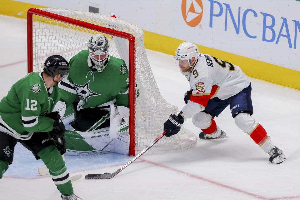 Florida Panthers center Sam Bennett (9) attempts a shot between Dallas Stars center Radek Faksa (12) and goalie Jake Oettinger, center, in the third period of an NHL hockey game in Dallas, Sunday, Jan. 8, 2023. (AP Photo/Gareth Patterson)