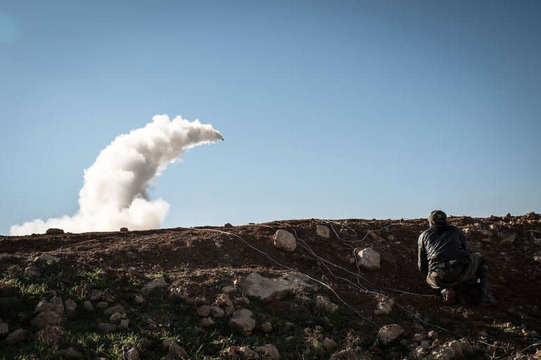 Syrian rebels launch a missile near the Abu Baker brigade in Albab, 30 kilometres from the northeastern Syrian city of Aleppo, on January 16, 2013. More than 100 civilians have been killed in a new "massacre" in Syria, a watchdog said Thursday, as Russia slammed the United States for blaming deadly blasts at a university campus on the Damascus regime