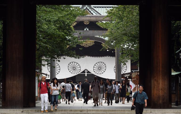 People visit the controversial Yasukuni Shrine in Tokyo on August 14, 2014, a day before the 69th anniversary of Japan's surrender in World War II