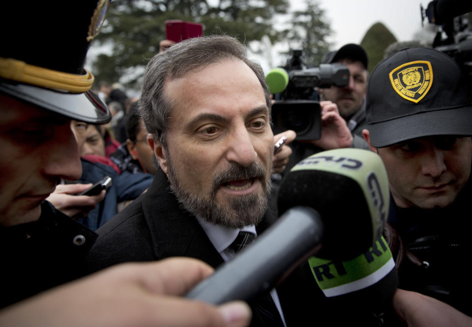 Louay Safi, center, spokesperson for the Syrian National Coalition, Syria's main political opposition group, is surrounded by UN security as he leaves a press briefing at the United Nations headquarters in Geneva, Switzerland, Thursday Jan. 30, 2014. Syrian negotiators have resumed their peace talks involving U.N.-Arab League mediator Lakhdar Brahimi, a day after President Bashar Assad's adviser rejected the opposition's call for a transitional governing body. (AP Photo/Anja Niedringhaus)