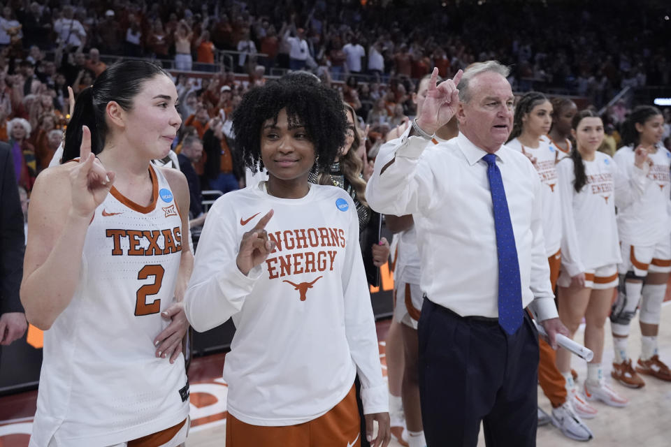 Texas guard Rori Harmon, second from left, stands with teammate guard Shaylee Gonzales (2) and head coach Vic Schaefer during the school song following their win over Alabama in a second-round college basketball game in the women's NCAA Tournament in Austin, Texas, Sunday, March 24, 2024. The Texas Longhorns lost standout point guard Rori Harmon to a knee injury in December. Instead of slinking into the shadows of a long recovery for next season, Harmon has been team cheerleader, unofficial assistant coach and invaluable mentor for freshman Madison Booker, who took over the offense in her place and has the No. 1 seed Longhorns roaring into the Sweet 16. (AP Photo/Eric Gay)