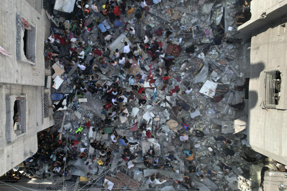 Palestinians look for survivors of an Israeli bombardment of the Gaza Strip in the Nusseirat refugee camp, Tuesday, Oct. 24, 2023. (AP Photo/Hatem Moussa)