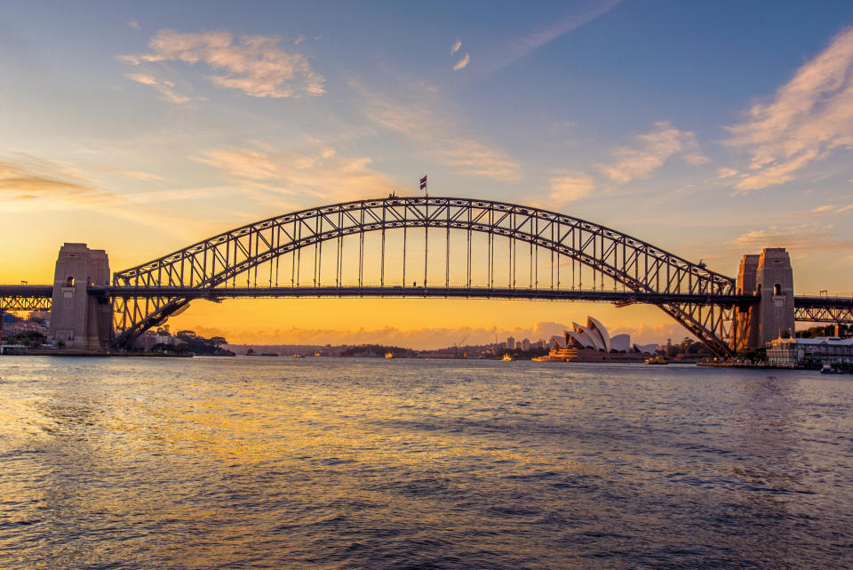 Iconic Sydney Harbour Bridge and Opera House taken at sunrise from Blues Point Reserve. Source: Getty