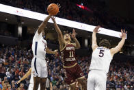 Boston College's Makai Ashton-Langford (11) shoots between Virginia's Reece Beekman, left, and Ben Vander Plas during the first half of an NCAA college basketball game in Charlottesville, Va., Saturday, Jan. 28, 2023. (AP Photo/Mike Kropf)