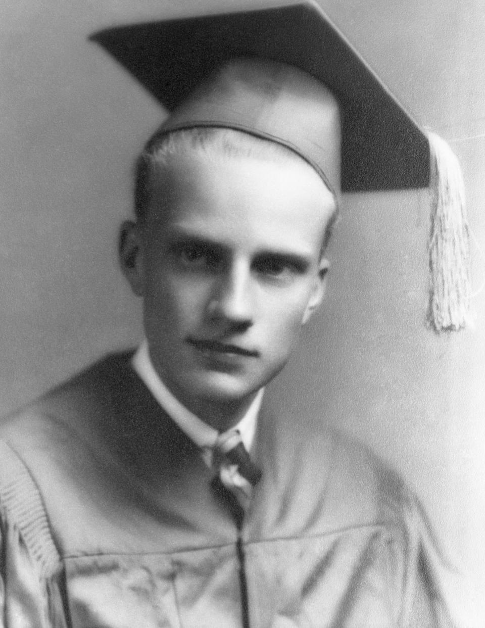 Graham wears a cap and gown at age 17 on his graduation from Charlotte High School. Shortly before this date, Billy had embraced a charismatic, evangelical form of Christianity&nbsp;at a local revival meeting.