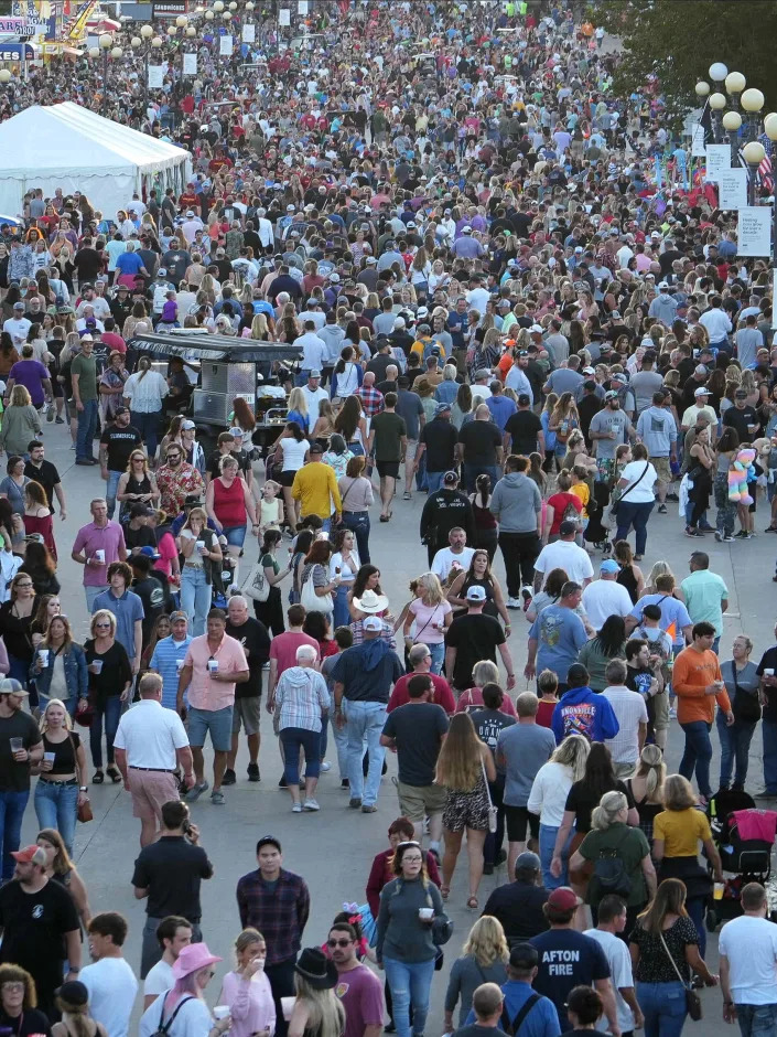 Large crowds make their way along Grand Avenue during the Iowa State Fair on Saturday, Aug. 20, 2022, in Des Moines.