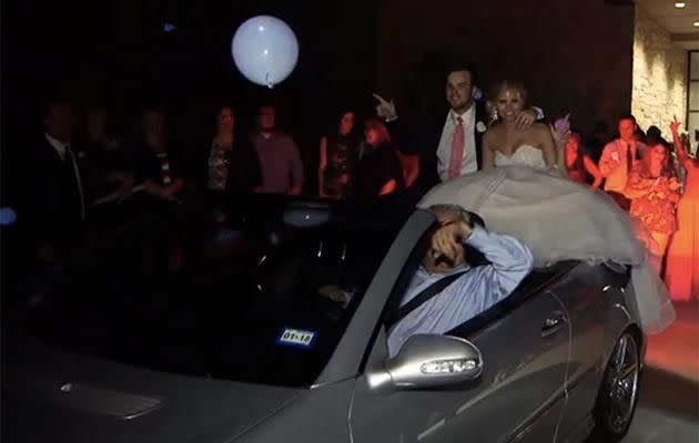 Their wedding guests surrounded the car. Photo: YouTube