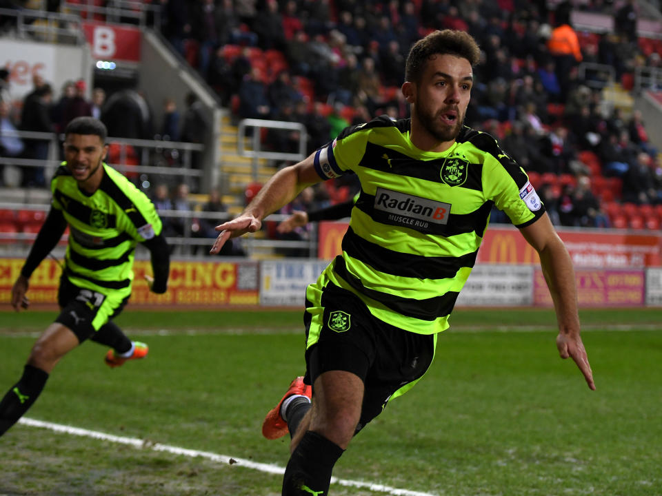 Tommy Smith wheels away after scoring Huddersfield's winner at Rotherham: Getty