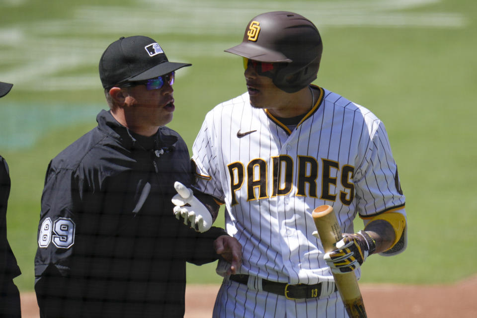 San Diego Padres' Manny Machado reacts alongside first base umpire Cory Blaser after being called out on an automatic strike during the first inning of a baseball game against the Arizona Diamondbacks, Tuesday, April 4, 2023, in San Diego. (AP Photo/Gregory Bull)