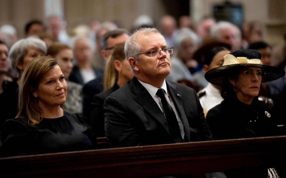 Australia's Prime Minister Scott Morrison (C) and his wife Jenny Morrison (L) attend a special prayer service to commemorate the death of Prince Philip, Duke of Edinburgh, at St Andrew's Cathedral in Sydney  - BIANCA DE MARCHI 