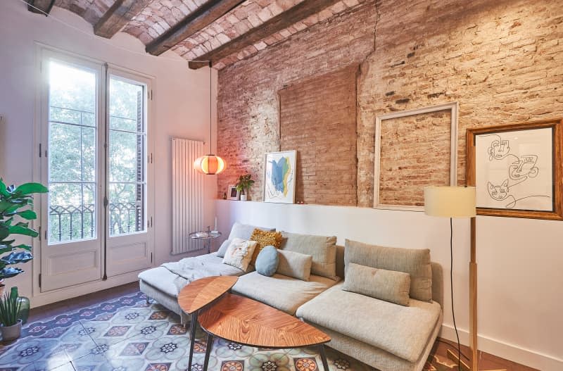 Brick lined walls in living room of newly renovated apartment.