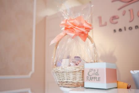 A raffle box for beauty supplies, with proceeds going to a charity, is seen at the entrance of Le'Jemalik Salon and Boutique ahead of the Eid al-Fitr Islamic holiday in Brooklyn, New York, U.S., June 21, 2017. Picture taken on June 21, 2017. REUTERS/Gabriela Bhaskar