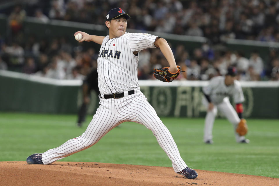 Japan starting pitcher Shun Yamaguchi delivers a pitch against South Korea in the first inning of their Premier12 baseball tournament final game at Tokyo Dome in Tokyo, Sunday, Nov. 17, 2019. (AP Photo/Toru Takahashi)