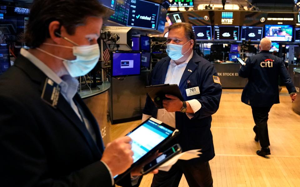 Traders work on the floor at the New York Stock Exchange in New York, on July 29, 2021. - Wall Street stocks climbed early July 29 following another round of mostly strong earnings and US data that showed strong second-quarter growth that lagged expectations. (Photo by TIMOTHY A. CLARY / AFP) (Photo by TIMOTHY A. CLARY/AFP via Getty Images)