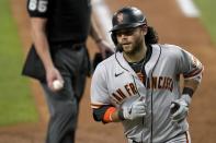 San Francisco Giants' Brandon Crawford turns to the dugout after scoring on his solo home run during the sixth inning of a baseball game against the Texas Rangers in Arlington, Texas, Tuesday, June 8, 2021. (AP Photo/Tony Gutierrez)