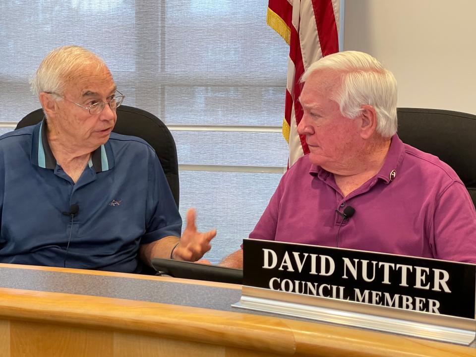 Pekin City Council members Lloyd Orrick (left) and Dave Nutter discuss the agenda for Monday's meeting.