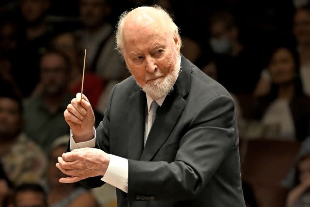 <p>Shannon Finney/Getty</p> John Williams conducting a concert at Kennedy Center Concert Hall