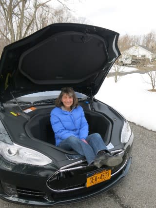 2013 Tesla Model S electric sport sedan on delivery day, with Lisa Noland sitting in the front trunk